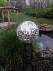 Mirror mosaic ball in a garden