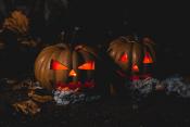 2 jack-o-lanterns 1 scary, 1 friendly - both glowing orange