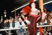 A performer in red walks for a panel of judges in this still from the "Paris is Burning" documentary.