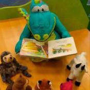 plush dinosaur reading story to other toys