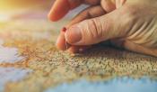 map with hand holding a pin map with hand holding a pin
